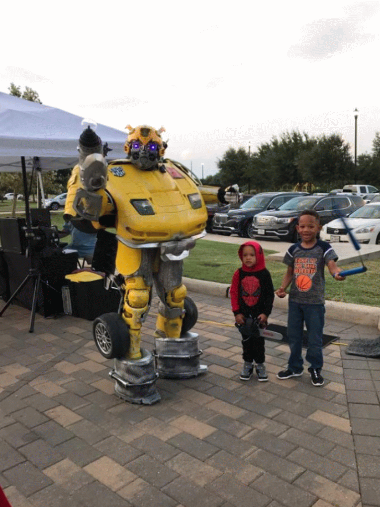Hire this transforming yellow robot superhero mascot for your child's birthday party in Houston and Sugarland when you want an awesome costume, great games, & super cool photo props.