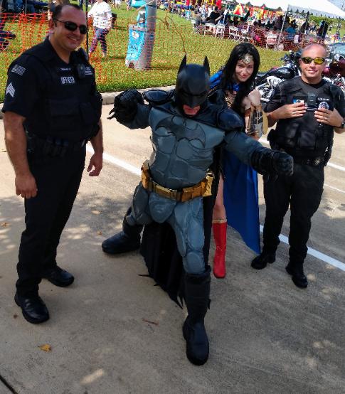 Party characters for kids in Houston with 2 Clearlake police officers and BatHero, Wonder Hero at Warwick construction picnic